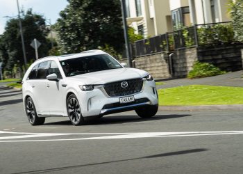 Mazda CX-90 taking a corner in white