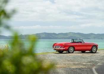 1965 MGB parked on a New Zealand shorefront, showing rear