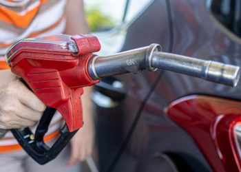 Person holding petrol pump nozzle