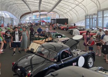 Crowd gathering around collection of MG cars at Centennial Celebration in Auckland
