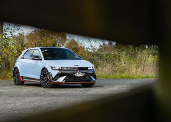 Hyundai IONIQ 5 N in blue, front quarter shot, framed by a fence