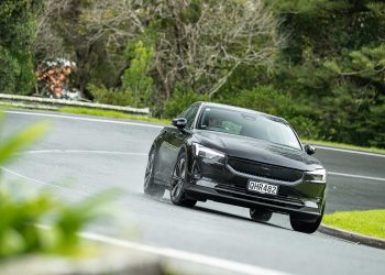 Polestar 2 cornering shot, in the rain front on