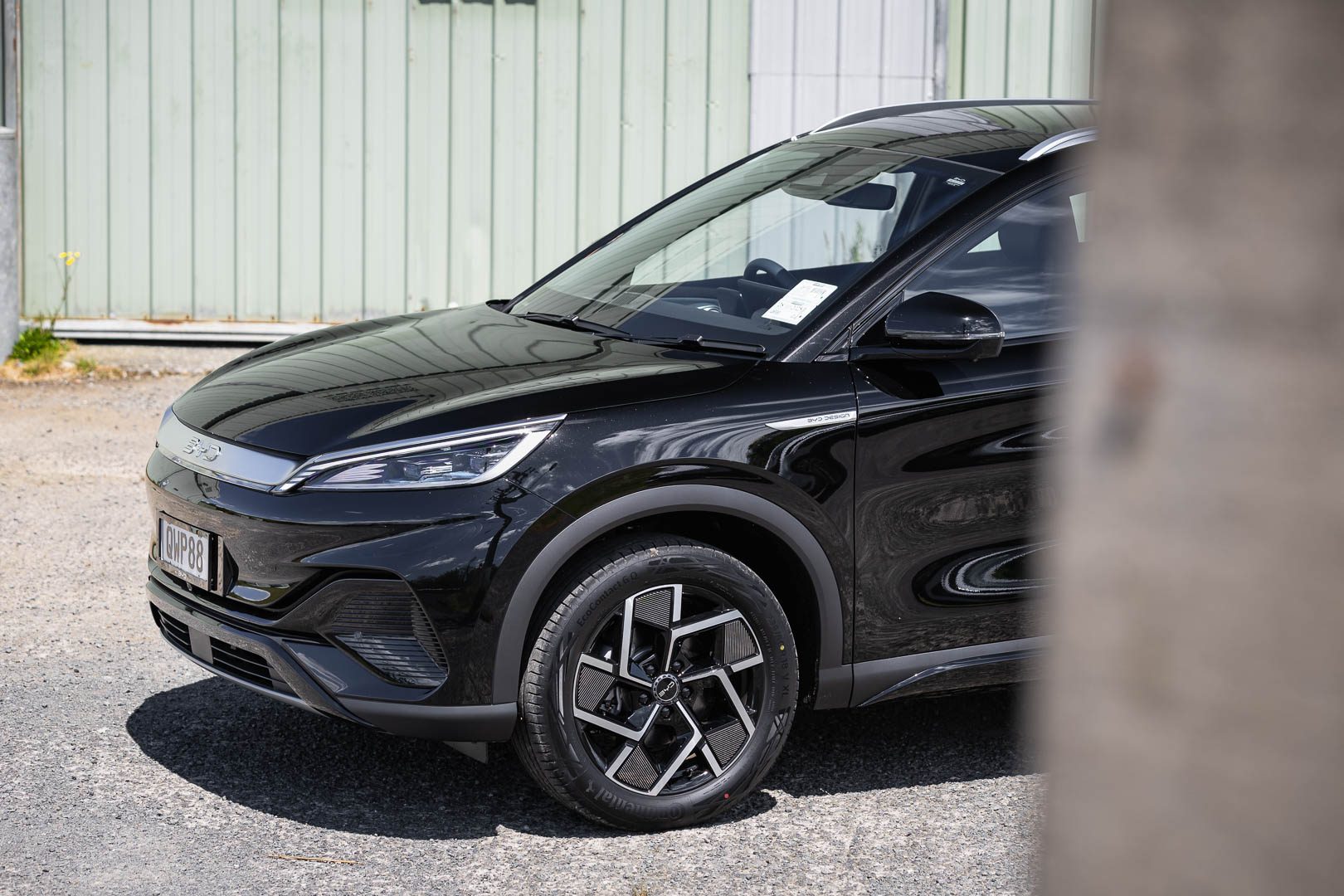 Black BYD Atto 3 with a green background