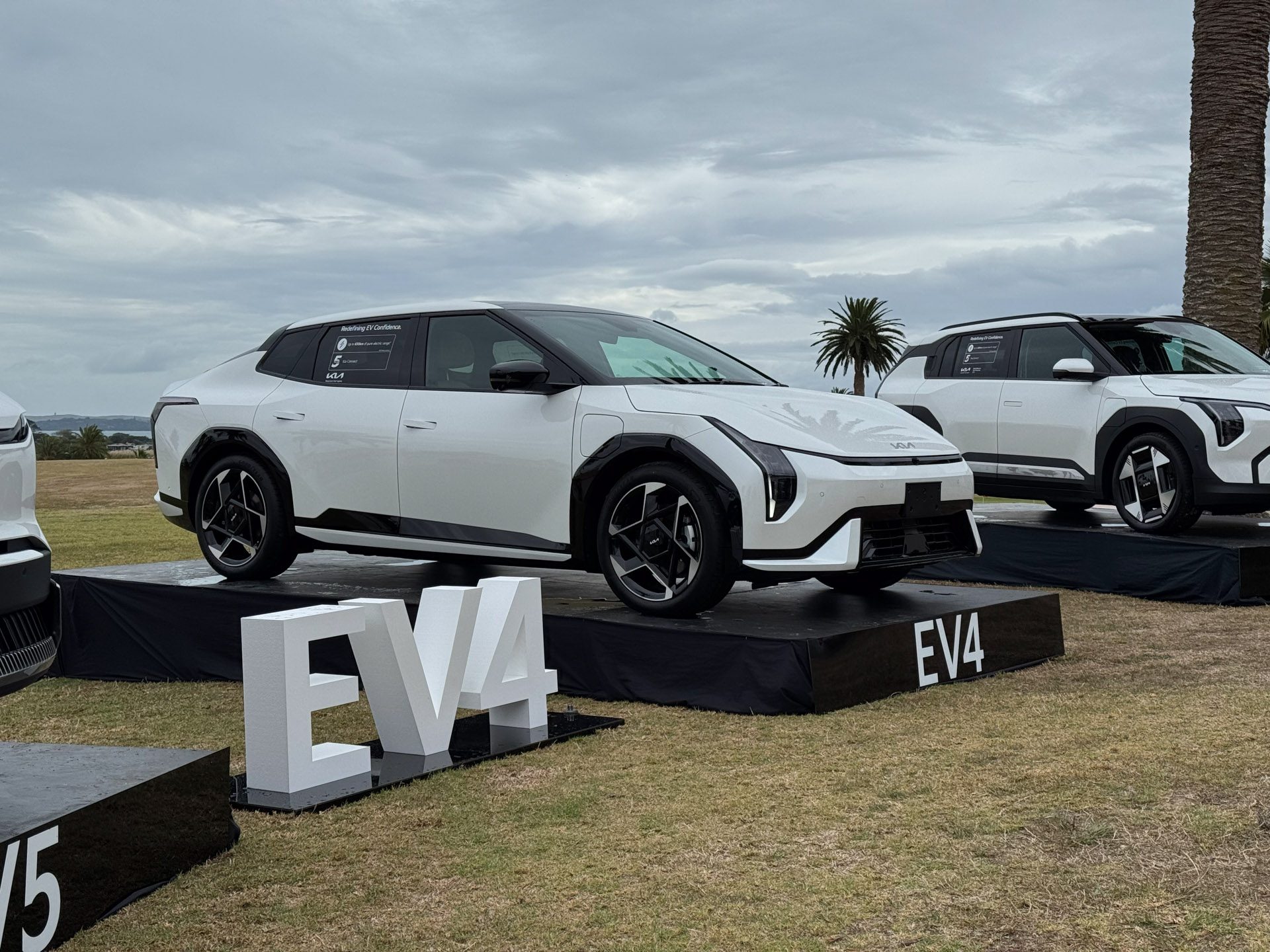 Kia Ev4 on a stage under cloudy skies