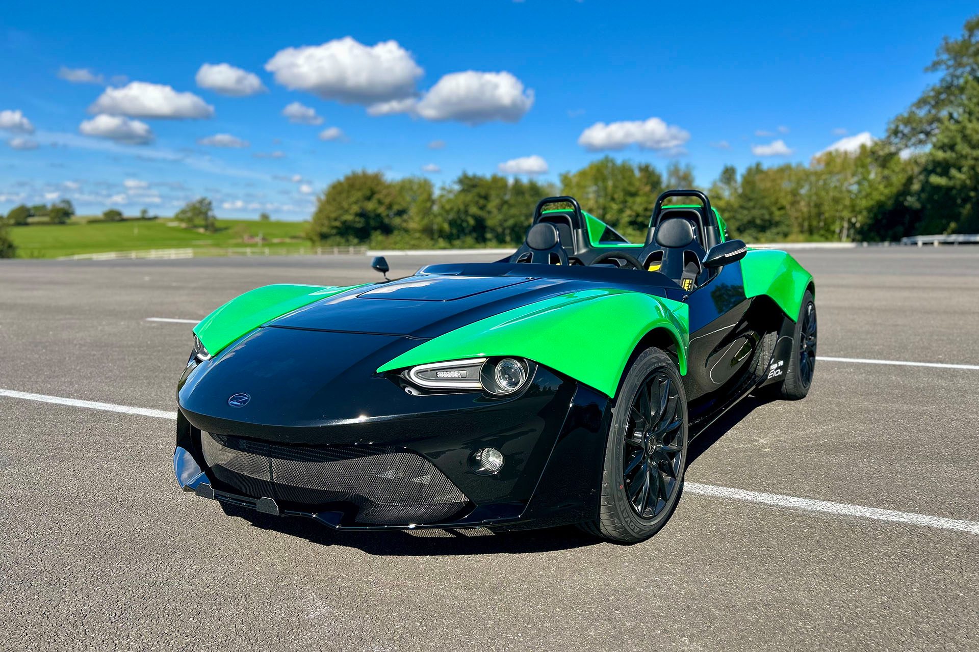Zenos E10 RZ in green and black under blue skies