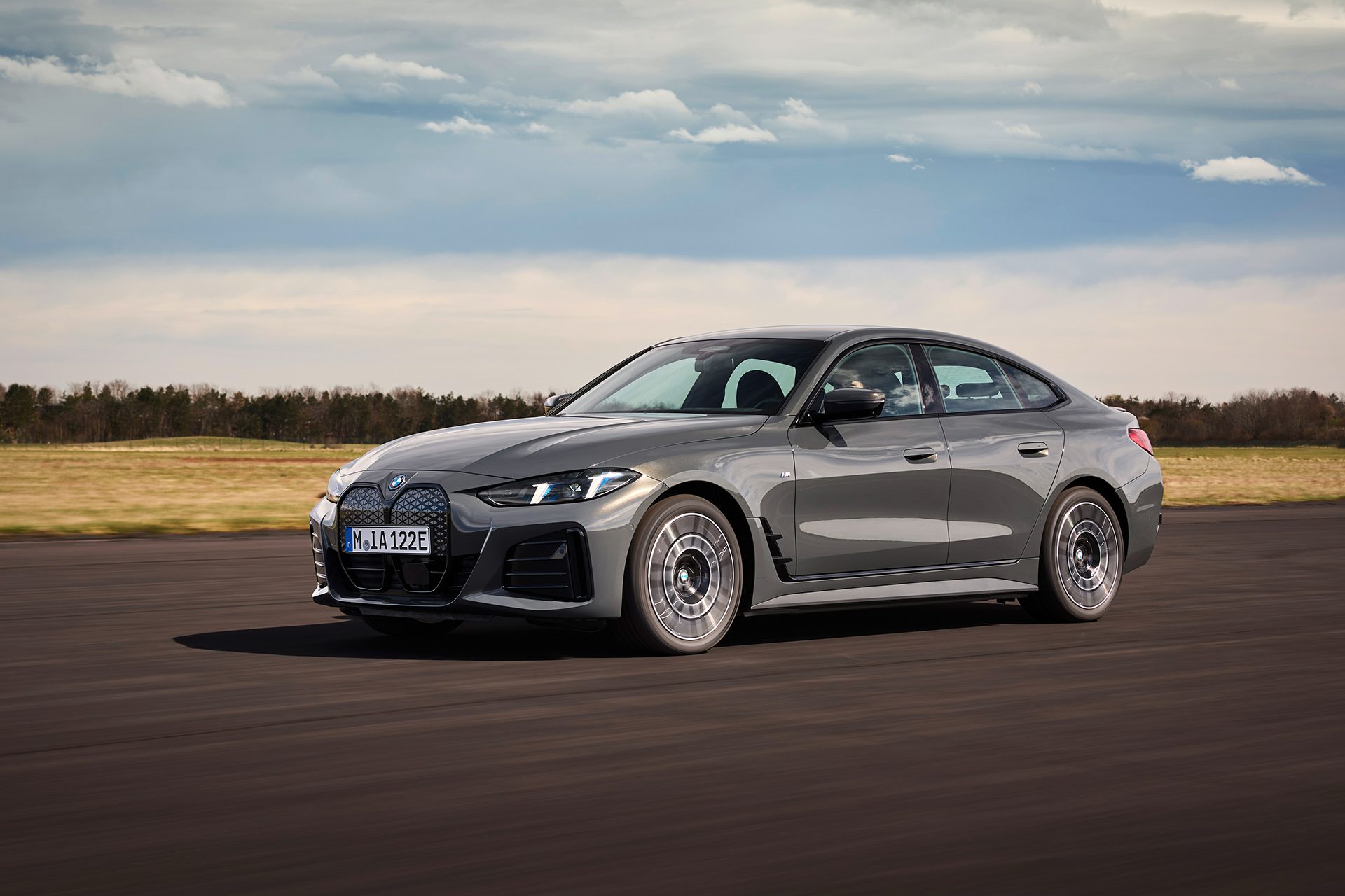 BMW i4 on tarmac under cloudy skies